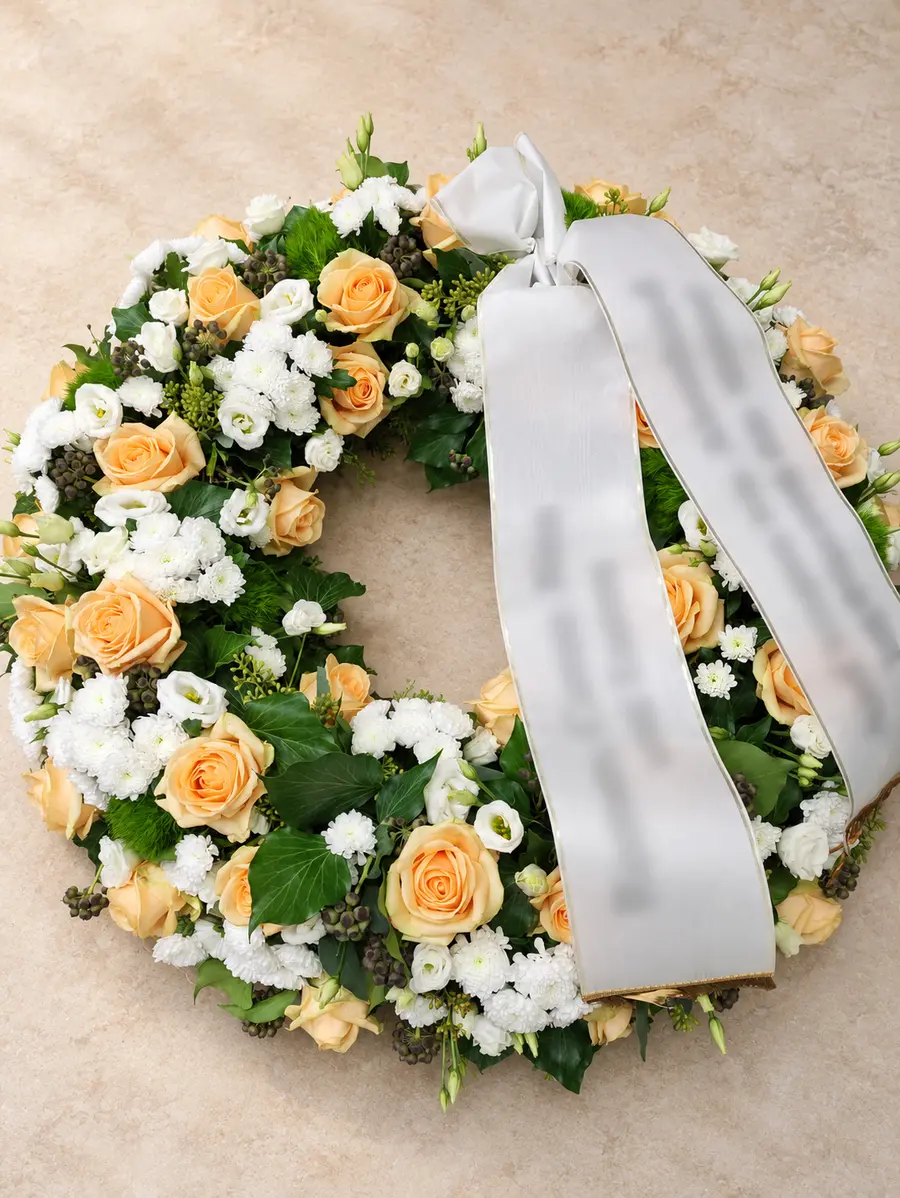 Trauerkranz mit apricotfarbenen Rosen und weißen Blüten